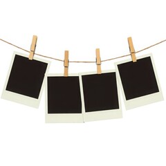 Four blank instant photos hanging on a line isolated on white background
