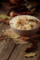 Traditional German sauerkraut on a old rustic wooden table.