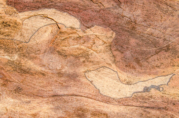 Red sandstone rock, natural tones, create mesmerizing texture and patterns, creating a natural earthy backdrop. 