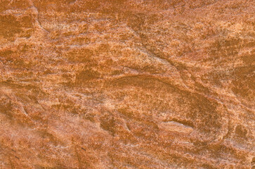 Red sandstone rock, natural tones, create mesmerizing texture and patterns, creating a natural earthy backdrop. 