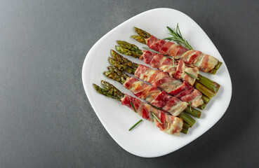 Grilled green asparagus wrapped in bacon.