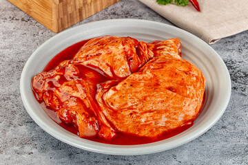 Raw chicken marinated thighs with skin