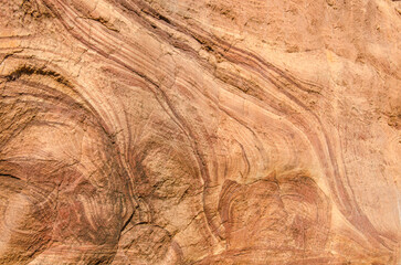 Red sandstone rock, natural tones, create mesmerizing texture and patterns, creating a natural earthy backdrop. 