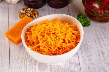 Yellow shredded cheddar cheese in the bowl