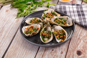 Gournet grilled oysters with onion and peanut