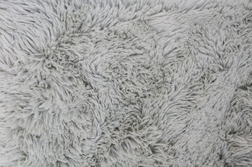 A close up shot of soft, gray, fluffy fabric, perfect for use as a cozy background texture.