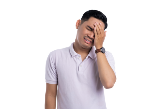 Frustrated young man touching forehead with pained expression, feeling regret and stress isolated on transparent background