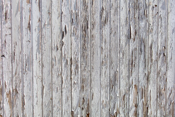 Obraz premium The image is of a wooden surface with a lot of peeling paint