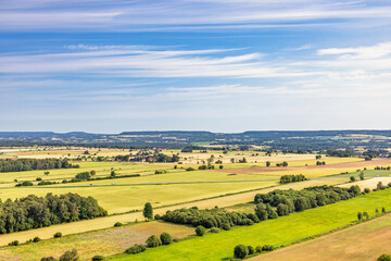 Aerial view at a cultivated landscape with fields on a plain in the summer