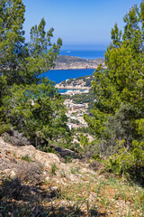 View through the trees towards a village on the coast of Mallorca