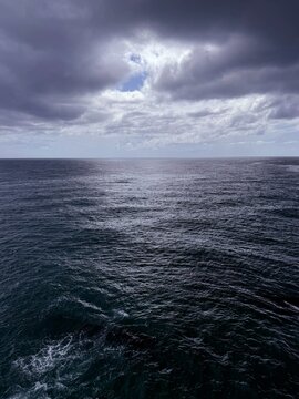 Stormy clouds over dark ocean waves.