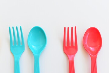 colorful spoon and fork isolated on white background, plastic cutlery for picnic