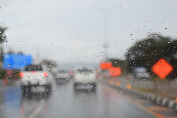 car on highway road with rainny season, blurred image