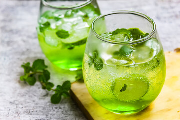 some mojito drinks with lime and mint leaves
