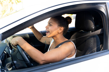 Angry cuban woman screaming while driving a car