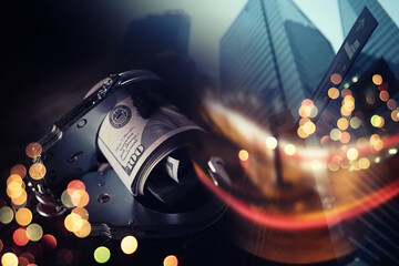  Double exposure city and hands of a man with handcuffs on a background of us dollars. Fraud, cyber...
