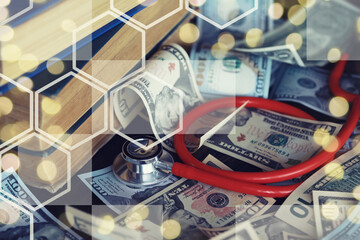 Close up red stethoscope on the US dollar banknote on wooden table. Health check or money and...