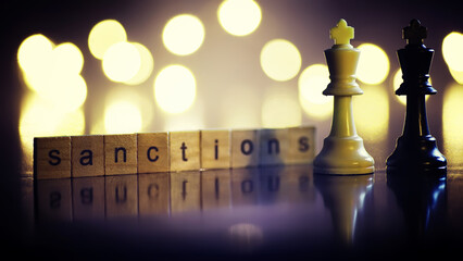word sanctions spelled in letters on table made of wooden block letters with dramatic lighting and...