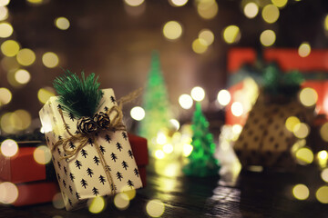 Gift boxes against a background bokeh of twinkling party lights. Luxury New Year gift. Christmas gift. Christmas background with gift box. Christmastime celebration