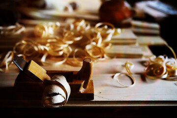 Hand planer with wooden sawdust. On a wooden background. High quality photo