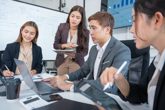 Laptop, professional asian business team in meeting or data analysis for group project collaboration or office employees discussing planning, business people, technology - Powered by Adobe