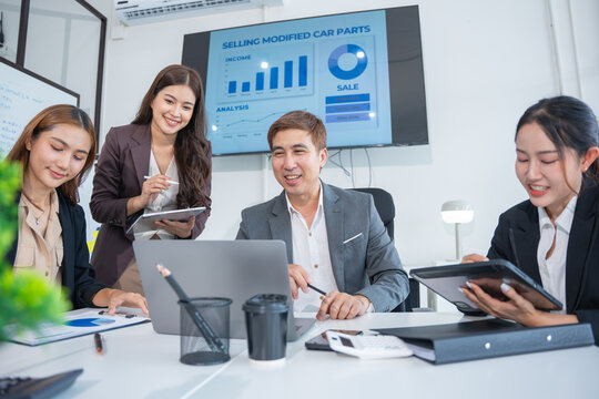 Group of professional business people or accountants working together on financial investment on calculator, doing calculation, analyzing business growth and marketing on graph in modern office.
