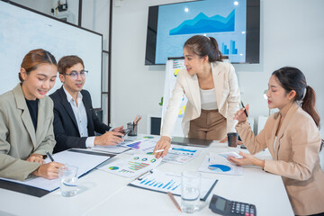 Business meeting using laptop computer, calculator, stock market graph paper for analysis. Business meeting and market research team. Finance and analysis concept in office.