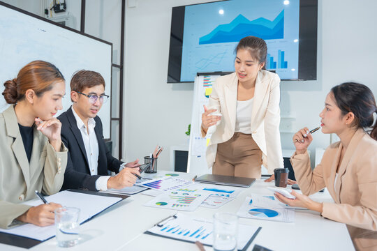 Business meeting using laptop computer, calculator, stock market graph paper for analysis. Business meeting and market research team. Finance and analysis concept in office.