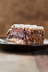 Piece of chocolate cake on rustic background. Close up.	