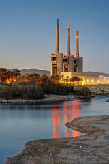 The shutdown thermal power station and the mouth of the Besos river at Sant Adria near Barcelona at twilight