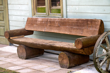 An antique bench made from logs.