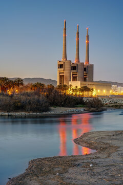The shutdown thermal power station and the mouth of the Besos river at Sant Adria near Barcelona at twilight