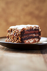 Piece of chocolate cake on rustic background. Close up.	