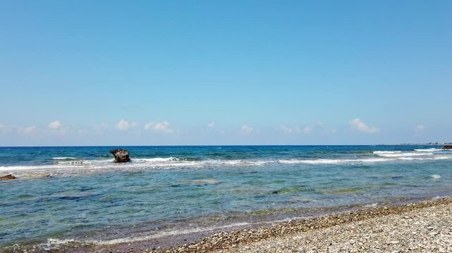 Waves crash against rocks in the sea and along the shore at Mandria Beach, Cyprus. A raw, beautiful moment showing nature&rsquo;s rhythm&mdash;ideal for coastal, travel, or relaxation themes.