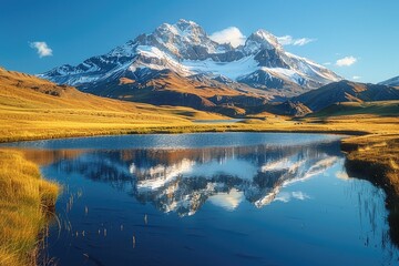 Obraz premium Majestic mountain range reflected in a tranquil lake.