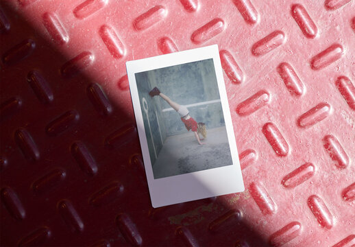 Mockup of Mini Polaroid on red metallic Textured Surface. 46 x 62 mm, Vertical.