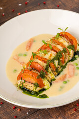 Stuffed chicken breast with tomato, mozzarella, cream and herb sauce