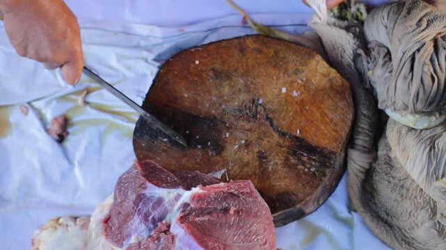 cutting beef or mutton using a knife for barbeque or Eid al-Adha.
