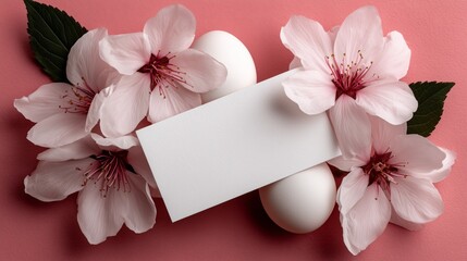 Minimal flat lay of Easter eggs and flowers arranged on pastel background with clean style and blank paper in center for message or promotion.