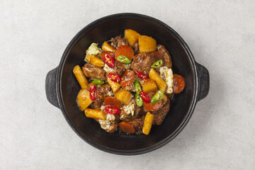  Jjimdak is a dish made by simmering chicken pieces with carrots, potatoes, garlic, peppers, green onions, onions, and glass noodles, and seasoning it with soy sauce or red pepper paste.