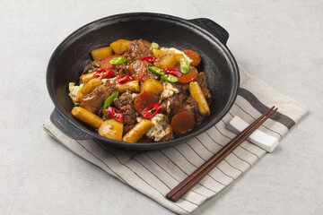  Jjimdak is a dish made by simmering chicken pieces with carrots, potatoes, garlic, peppers, green...