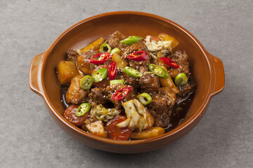  Jjimdak is a dish made by simmering chicken pieces with carrots, potatoes, garlic, peppers, green...