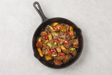  Jjimdak is a dish made by simmering chicken pieces with carrots, potatoes, garlic, peppers, green onions, onions, and glass noodles, and seasoning it with soy sauce or red pepper paste.