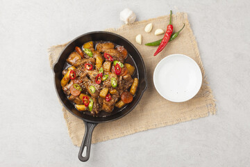  Jjimdak is a dish made by simmering chicken pieces with carrots, potatoes, garlic, peppers, green...