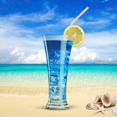 A glass of juice on a beach