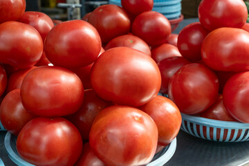 Vibrant red tomatoes symbolizing the essence of life and growth. Fresh tomatoes on display at a bustling market, inviting a taste of summer.