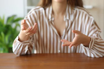 Gordijnen Woman hands gesturing while is talking at home © Antonioguillem