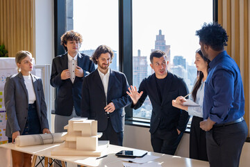 Team of architect, engineer and businessman having meeting on new property and real estate development project over the design and safety for modern living space in urban downtown