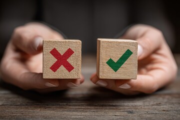 A person in a tie holding paper blocks . The focus is on the conceptual elements of success or failure.