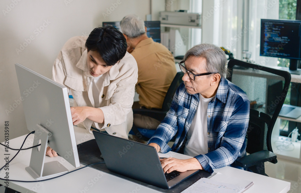 Wall mural group of asian senior in a collaborative software development analyzing flowcharts during a bootcamp
